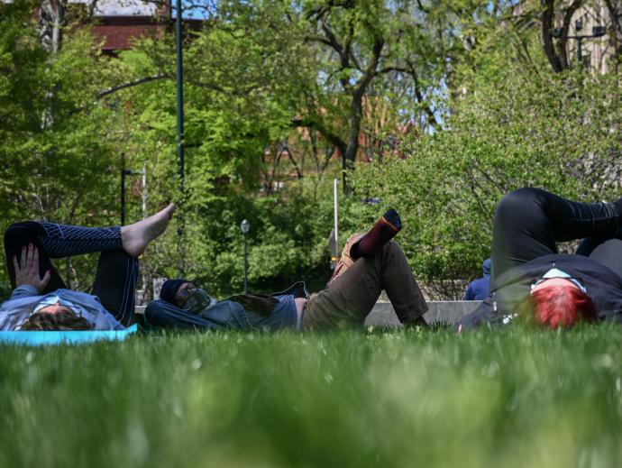 Students rest on the grass